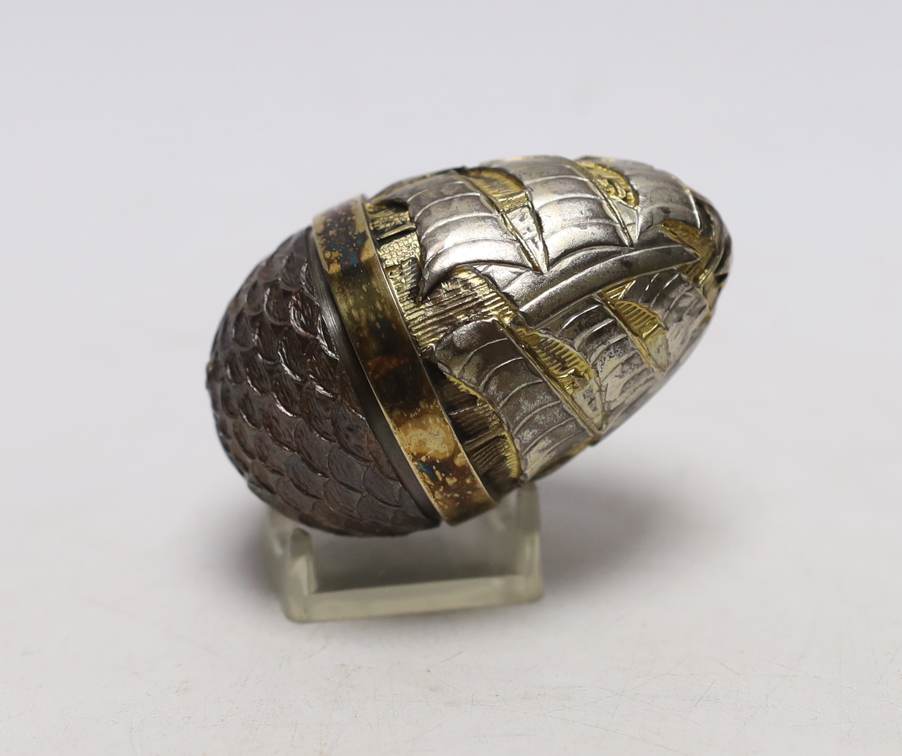 An Elizabeth II parcel gilt silver and enamel surprise egg, by Stuart Devlin, London, 1989, numbered 20, opening to reveal sailing yachts, 6x6mm.